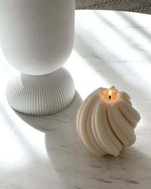Levi Sculptural Candle burning on table