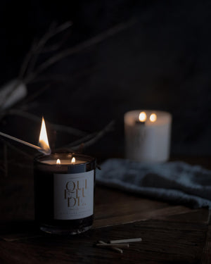 Scented Soy Candle on table with match stick being lit